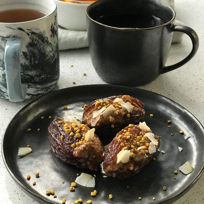 Dates stuffed with almond butter, bee pollen and coconut flakes snack